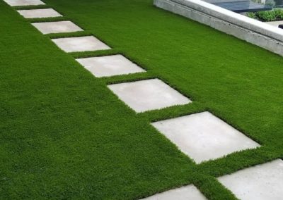 artificial grass between paving stones