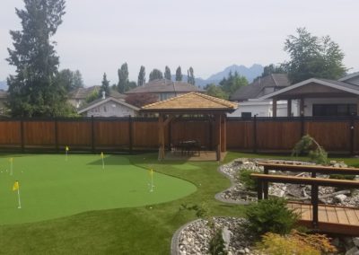 putting green with dry creek and a bridge