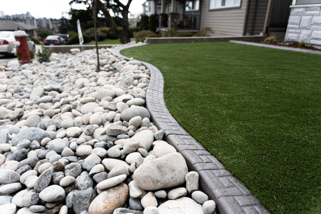 River rock, curb ease edging, artificial grass, low maintenance yard